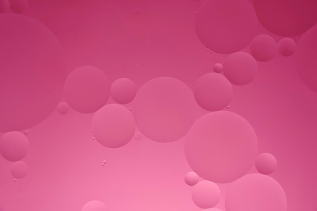 Fondo abstracto rosa con rayas de círculos de aceite y degradado