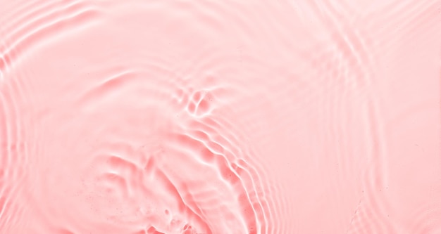 Fondo abstracto de superficie rosa agua Ondas y ondulaciones textura de crema hidratante cosmética aqua con burbujas