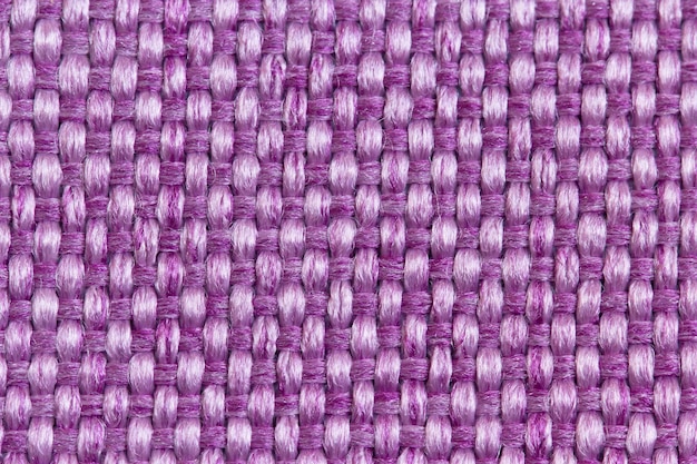 Fondo abstracto de tela de tapicería de una alfombra para muebles en gran tejido de púrpura
