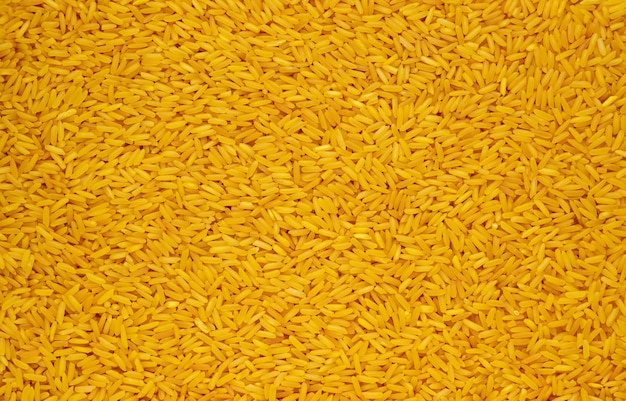 Fondo abstracto de la textura del arroz de la cúrcuma de los alimentos