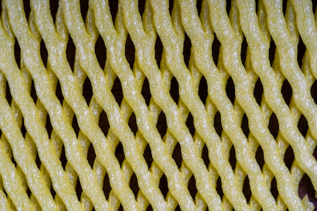 Fondo abstracto de textura de malla de plástico amarillo para cerrar la fruta