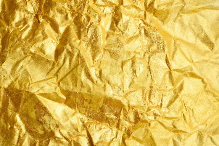 Foto fondo abstracto de la textura del papel dorado arrugado