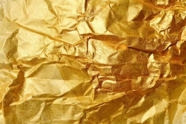 Foto fondo abstracto de la textura del papel dorado arrugado