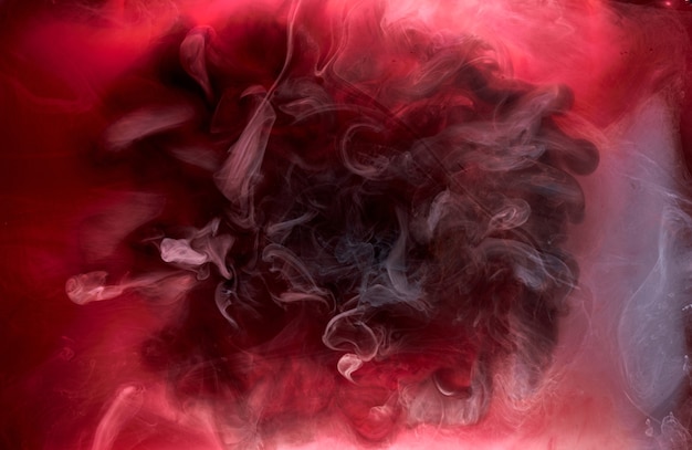 Fondo abstracto de tinta remolino de pigmento negro rojo, pintura de humo líquido bajo el agua