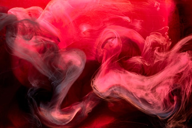 Fondo abstracto de tinta remolino de pigmento negro rojo, pintura de humo líquido bajo el agua