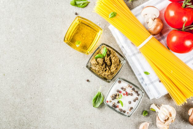 Fondo de alimentos, ingredientes para cocinar la cena. Espaguetis de pasta, verduras, salsas y especias.