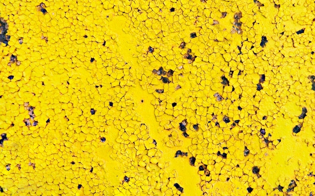 Fondo amarillo abstracto de pintura agrietada en una superficie de metal antiguo Espacio de copia, corrosión del metal