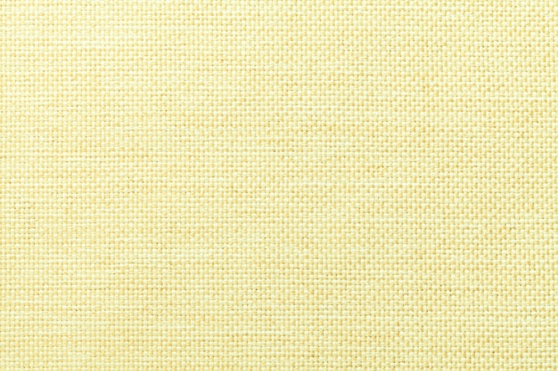 Fondo amarillo claro de la tela de ensacado tejida densa, primer. Estructura de la macro textil.