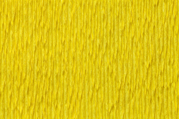 Foto fondo amarillo de textura de papel ondulado ondulado, primer plano.