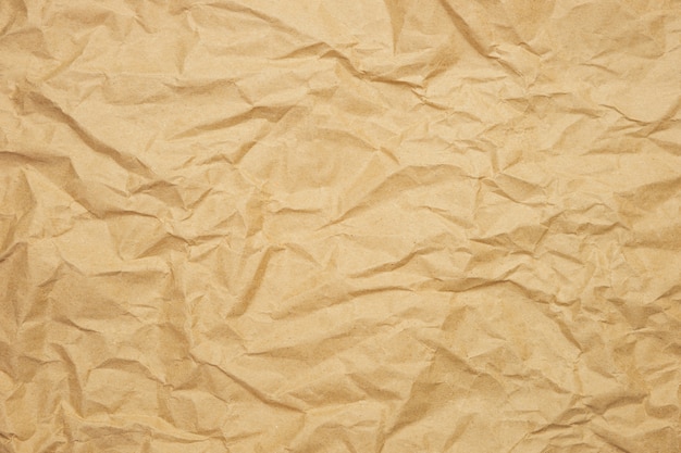 Foto fondo arrugado de papel marrón. textura de papel kraft para envolver. concepto de embalaje ecológico.