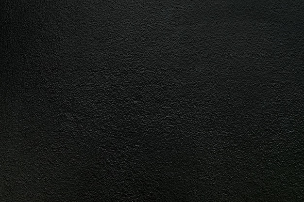 Fondo áspero negro de la textura del muro de cemento.