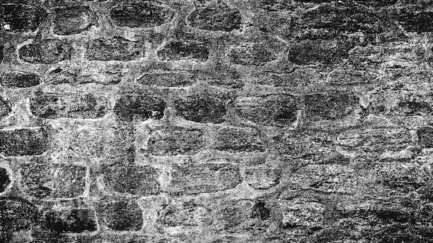 Fondo blanco y negro de la antigua muralla de piedra