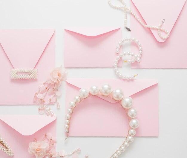 Fondo de boda, decorado con invitaciones rosas y joyas de perlas