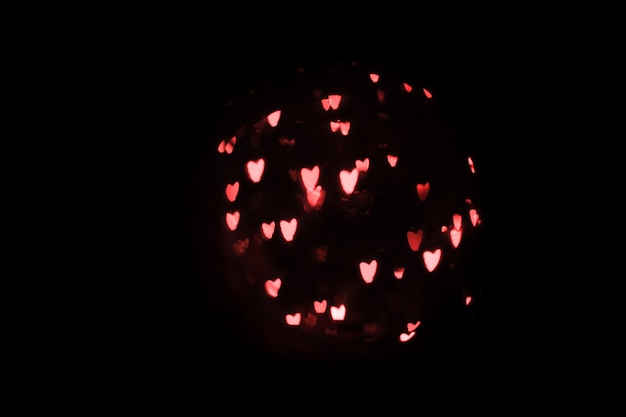 Fondo del bokeh del corazón, concepto del día de tarjeta del día de San Valentín del amor. Corazones sobre un fondo negro