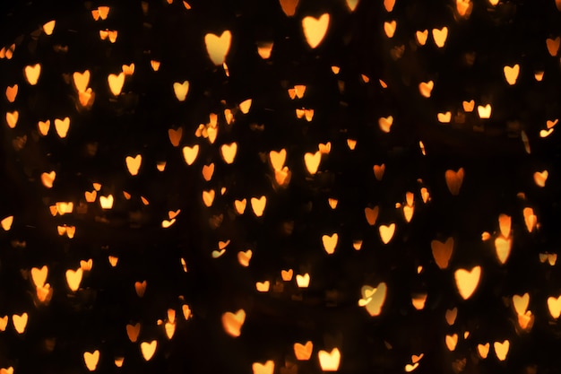 Fondo del bokeh del corazón, concepto del día de tarjeta del día de San Valentín del amor. Corazones sobre un fondo negro