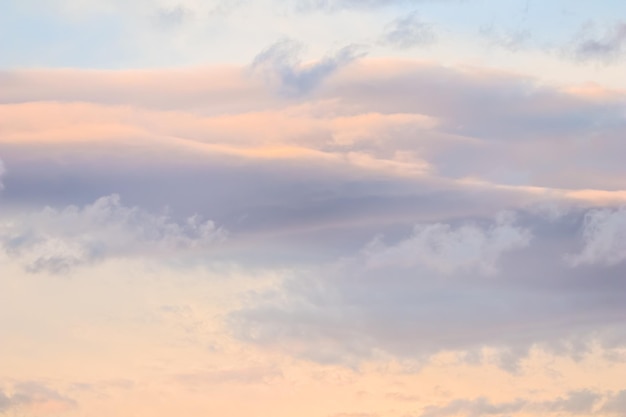 Fondo de cielo azul con nubes blancas y rosadas al atardecer