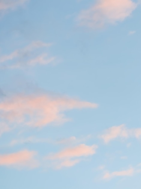 Fondo de cielo azul con nubes de color rosa pálido al atardecer