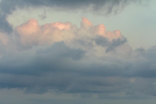 Fondo de cielo borroso con nubes rosas y azules al atardecer.