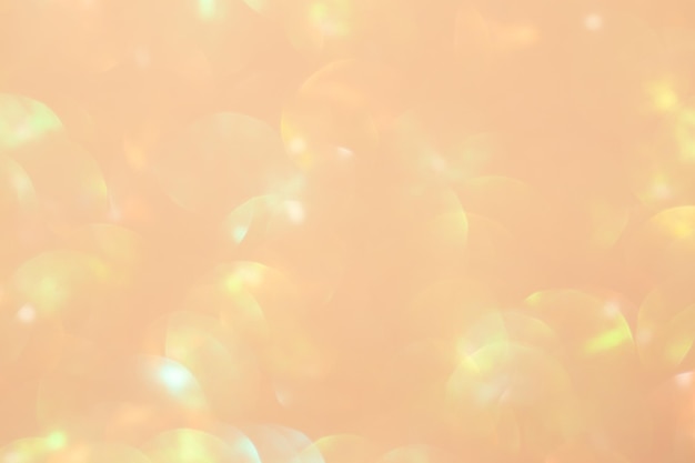 Fondo de color melocotón con luces navideñas borrosas que muestran el color melocotón de 2024