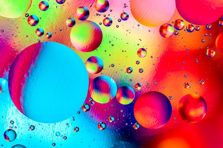 Foto fondo colorido abstracto con aceite en la superficie del agua. gotas de aceite en agua psicodélica abstracta. planetas del espacio y del universo con estilo de imagen abstracta psicodélica.