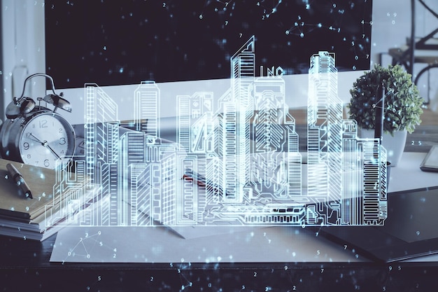 Fondo de computadora de escritorio en oficinas y edificios de la gran ciudad dibujo de holograma Doble exposición Concepto de ciudad inteligente