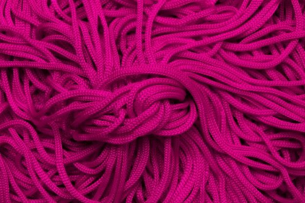 Fondo de cordones textiles de color púrpura brillante.