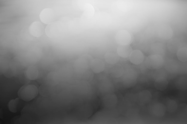 El fondo degradado de bokeh borroso negro y gris oscuro tiene un poco de luz abstracta