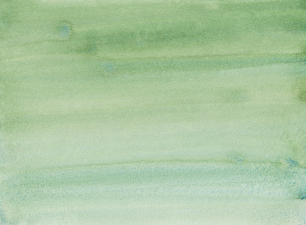Fondo degradado de color verde césped acuarela. Pintura de color verde agua ombre. Trazos de pincel sobre papel.