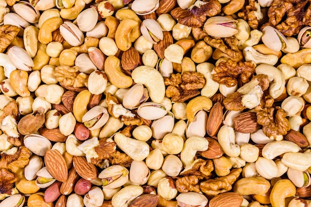 Foto fondo de los diversos frutos secos almendra anacardo avellana pistacho nuez comida vegetariana concepto de alimentación saludable