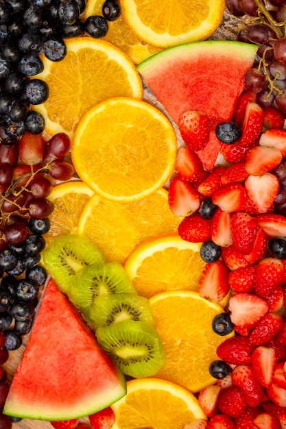 Foto fondo de frutas frescas las frutas mixtas saludables consisten en frutas tropicales y bayas variadas