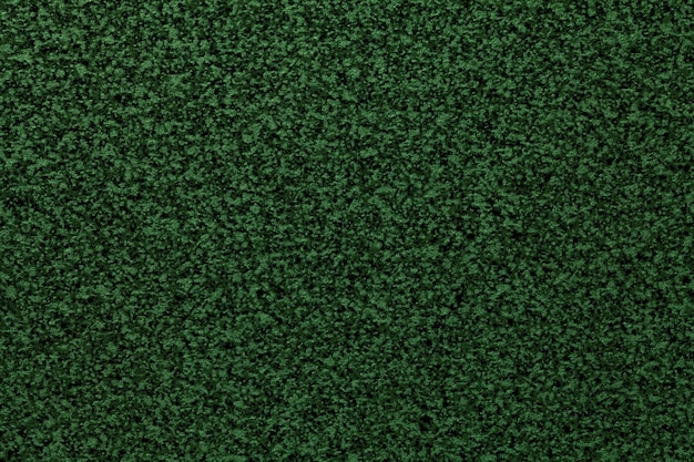 Fondo granulado de color verde oscuro liso de la mesa. Textura de superficie abstracta con patrón de miga pequeña para diseño de interiores y encimera de cocina.