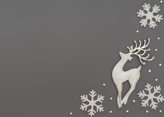 Fondo gris de Navidad o invierno con un ciervo y copos de nieve blancos y perlas
