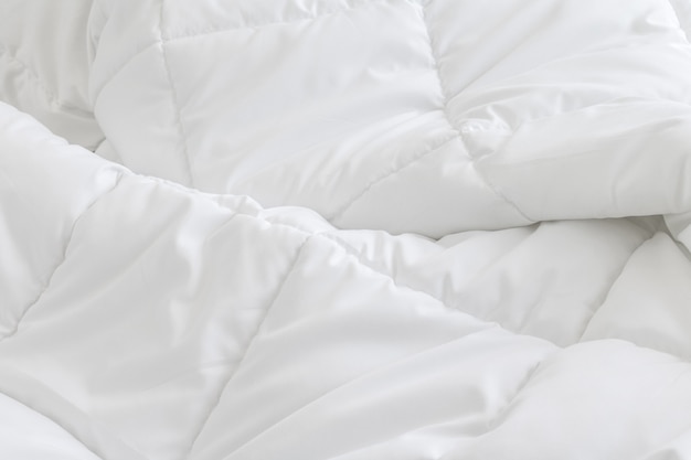 Foto fondo de hojas de cama blanca. concepto de cama desordenada.