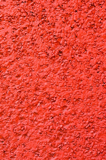 Foto fondo de hormigón pintado en rojo mezclado con grava