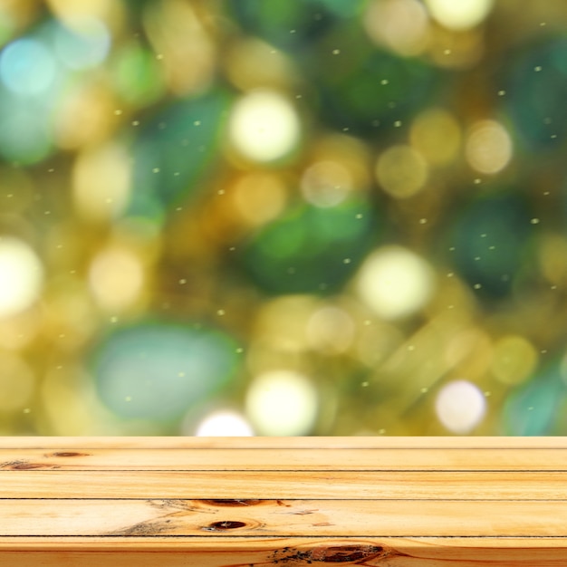 Fondo de luces bokeh azul y verde con exhibición de productos de mesa de madera