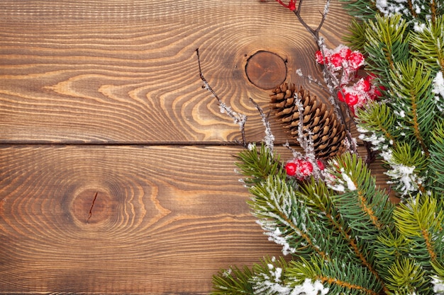Fondo de madera de la Navidad con el árbol de abeto de la nieve.