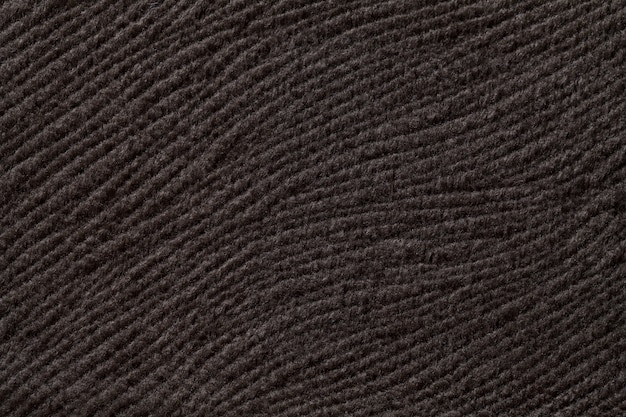 Fondo marrón oscuro de material textil suave, tela con textura natural,