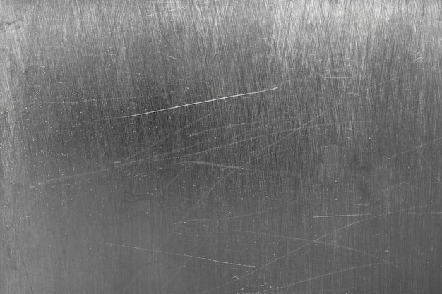 Fondo de metal oscuro, manchas de acero de textura gris del cepillo