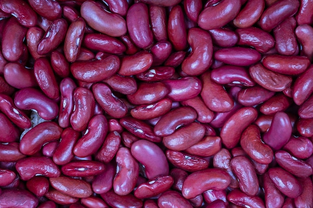 Fondo de muchos granos de frijoles secos Textura de frijoles rojos Fondo de alimentos Primer plano Fondo y textura de frijol