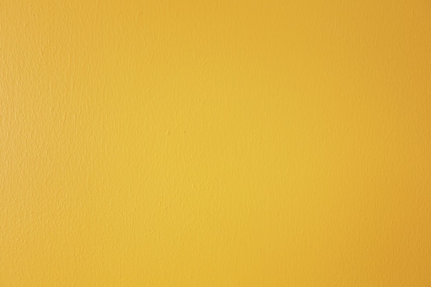 Fondo de muro de hormigón pintado de amarillo brillante