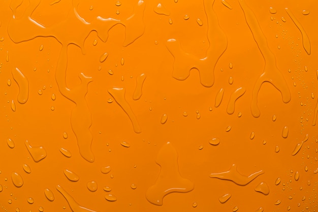 Fondo naranja de gota de agua de primer plano
