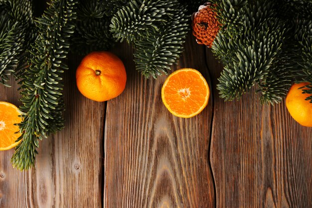 Fondo de navidad. árbol de navidad y mandarina o mandarina en mesa de madera.