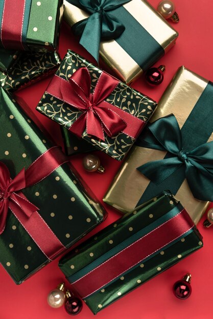 Fondo de Navidad con cajas de regalo con cintas de raso sobre fondo rojo.