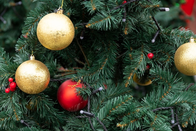 Fondo de Navidad, decoraciones de año nuevo en forma de bolas multicolores en un árbol de año nuevo. Copie el espacio.