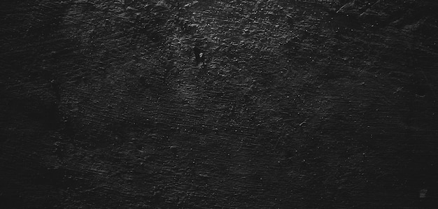 Foto fondo negro de cemento o piedra con textura de trazo de pincel natural.