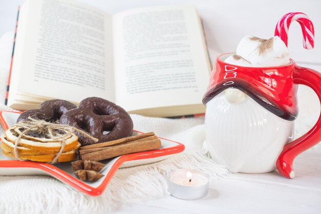 Fondo de Nochevieja Taza de Papá Noel con malvaviscos Galletas de Navidad libro abierto