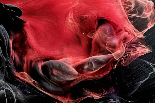 Fondo de océano abstracto negro rojo Salpicaduras y olas de pintura bajo el agua nubes de humo en movimiento
