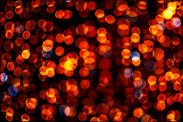 Fondo de oro abstracto borroso con bokeh, desenfocado muchas luces sobre fondo negro. Concepto de vacaciones de Navidad.