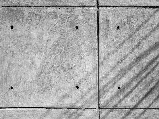 Fondo del panel posterior de la pared de hormigón. Textura de pared de hormigón de color gris con líneas y agujeros.