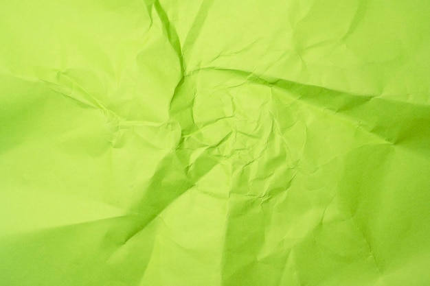 Foto el fondo de papel arrugado de color verde neón de primer plano